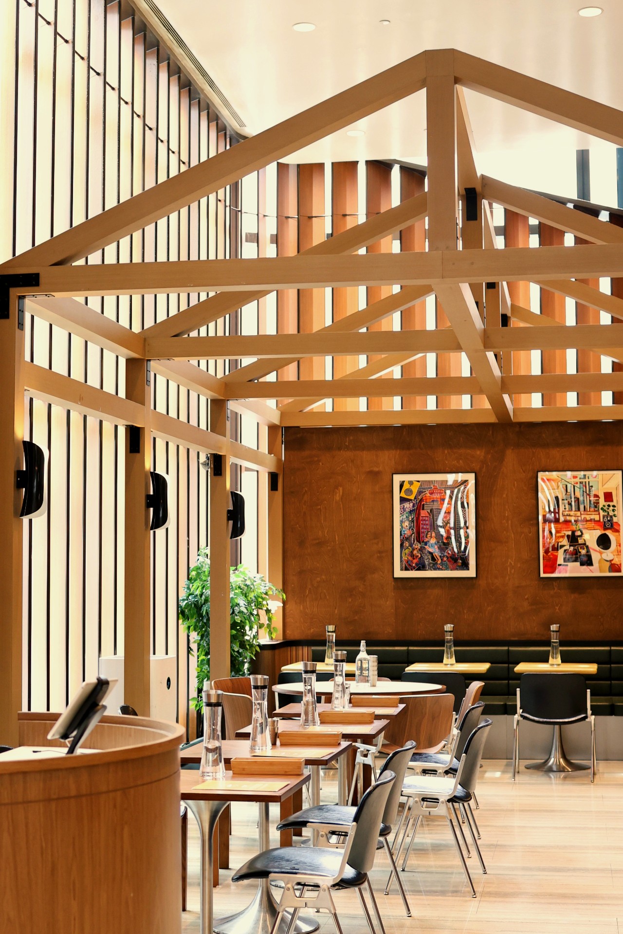 Warm interior of Lounge Hakuba with paper lanterns, walnut bar and mountain mural